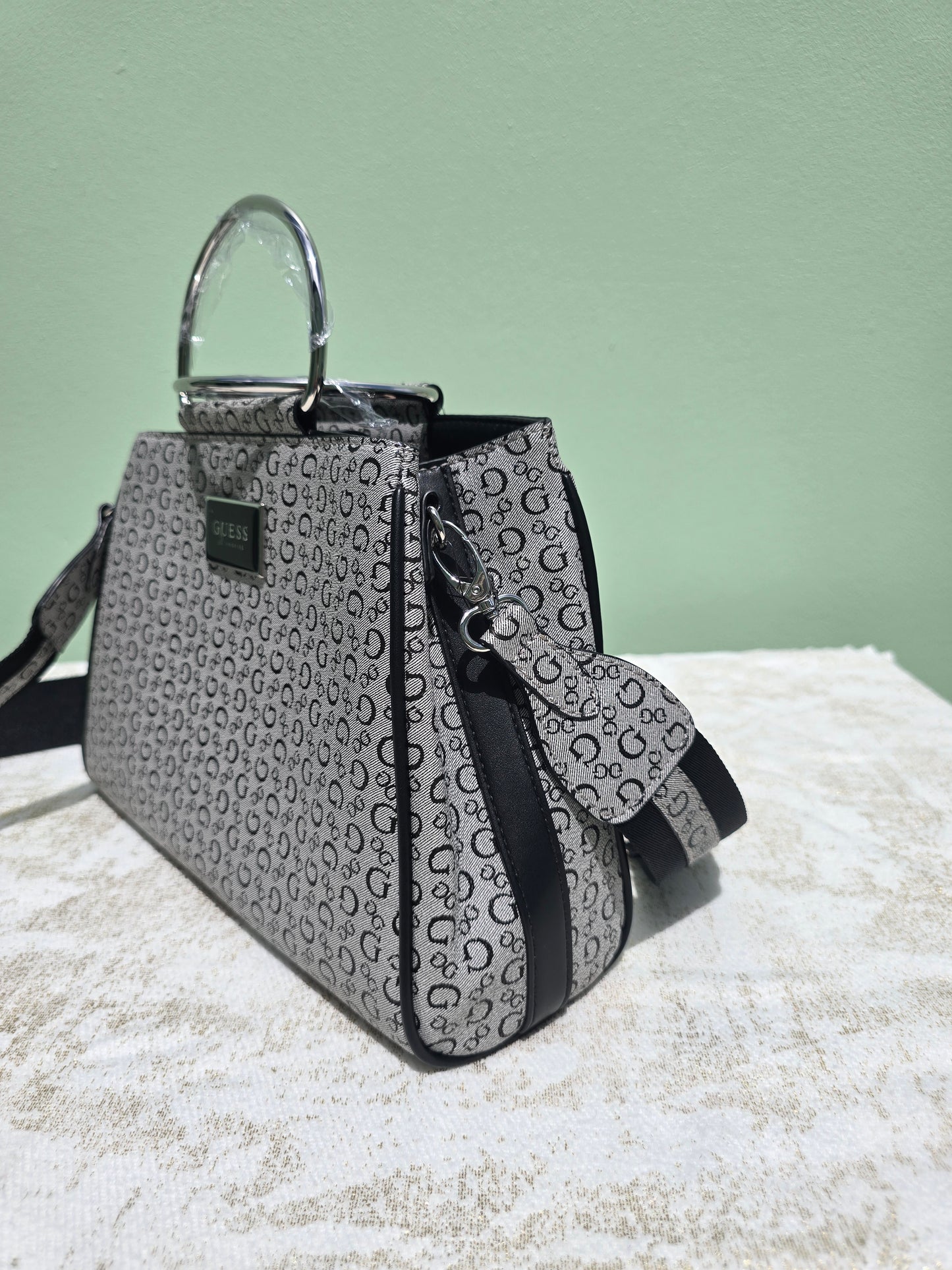 GUESS Satchel with silver metal handle with snap closure